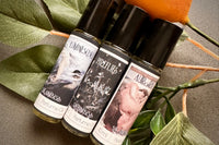 Muse Fragrances by SugarMuses® nestled in a small black box packed with organic moss and other botanicals.