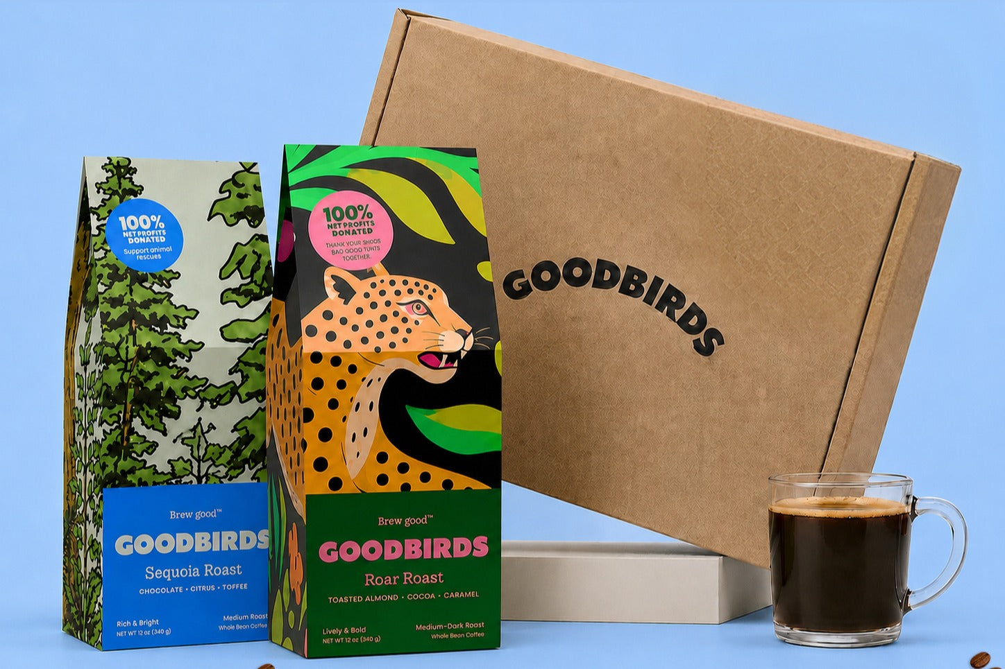 Two bags of coffee, a Goodbirds box and a cup of coffee, part of Goodbirds monthly coffee subscription of 2 12oz bags of coffee