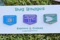Bug Badges backing card displaying three collectible enamel pins (Japanese Beetle, Walking Stick, Green Lacewing)