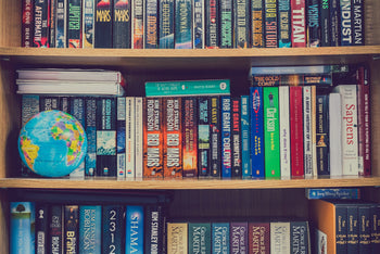 Bookshelf full of scifi books from very famous authors but also some less know, all with a shade of yellow.