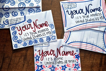 Three hand-decorated patriotic envelopes with red, white and blue designs, handwritten sample names and U.S. addresses.