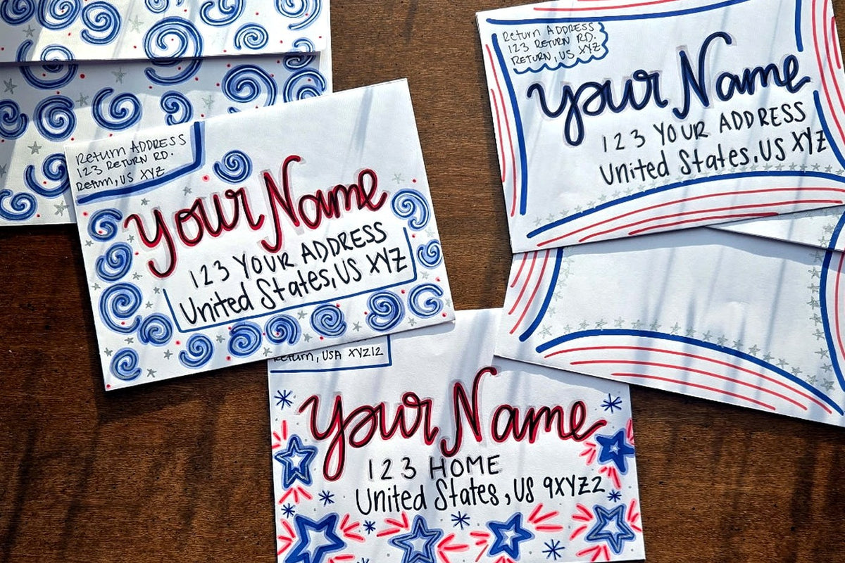 Three hand-decorated patriotic envelopes with red, white and blue designs, handwritten sample names and U.S. addresses.