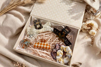 open hair candy club box featuring 6 curated fall hair accessories in neutral, brown, cream, and orange tones