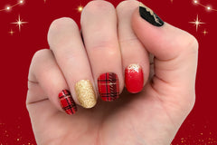 styled nail wraps displaying red, black and gold colors with a variety of patterns, including plaid, solid glitter, and ombre glitter