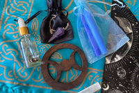 Elements in our Full Moon in Pisces Ritual box. A triple moon altar tile, amethyst pendulum in a satin bag, original, anointing oil, + more!