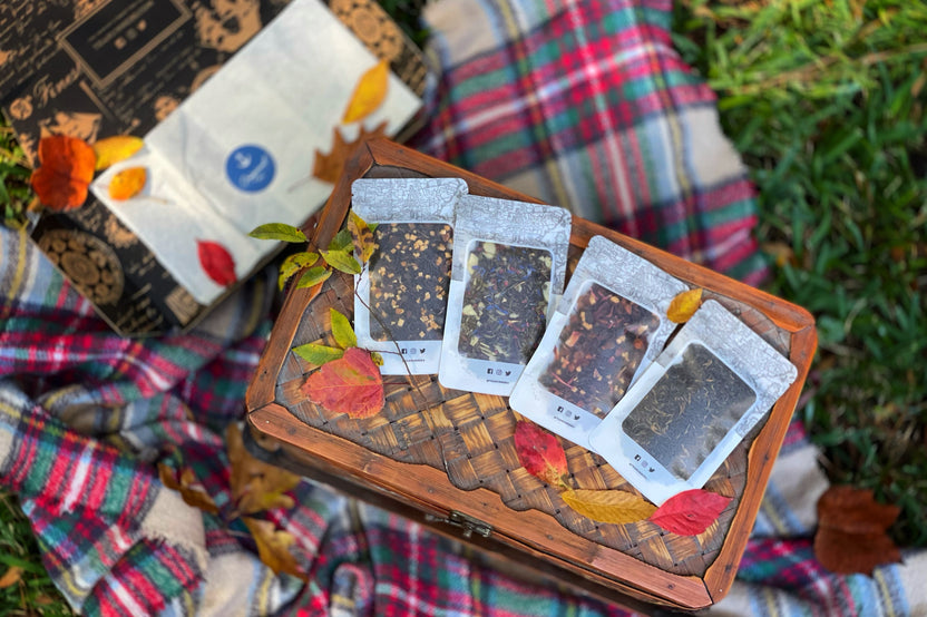 A hand pours tea from a kettle into a cup beside a Tea Runners subscription box and loose leaf tea packages