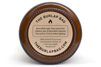 Bottom of a 9oz Burlap Bag amber jar with the kraft safety sticker: 100% natural US soy, hand poured in Austin, 7.2oz wax