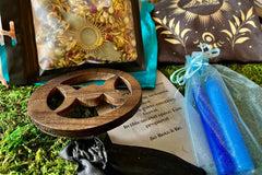 A beautiful depiction of an altar cloth, crystals, altar tile, ritual candles, and a ritual blend to be used in a bath or as an altar blend.