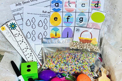 Spring themed and raindrop-themed counting and alphabet activities paired with colorful sensory bin filler.
