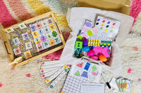 Raindrop and spring themed counting and alphabet activities paired with colorful sensory bin filler. 