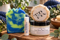 Handmade Acai and Blueberry soap bar with vibrant blue and green swirls beside natural skincare products