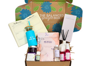 The Balanced Lifestyle Box for women showcases self-care products and a reusable tote bag for wellness journeys