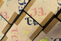 Boxes with specialty kids box tape on the outside of them, ready to be shipped, recycled packaging with recyclable tape