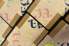 Boxes with specialty kids box tape on the outside of them, ready to be shipped, recycled packaging with recyclable tape