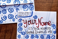 Hand-decorated patriotic envelope with red and blue swirl designs, handwritten sample name and U.S. mailing address.