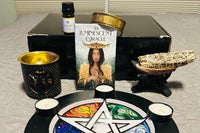 Oracle deck, essential oil burner, smudge stick, abalone shell, copper bracelet, essential oil, tea light candles