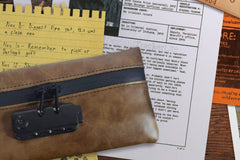 Close up photo of some papers that are included in the Breevello mystery escape game with some spy device included.