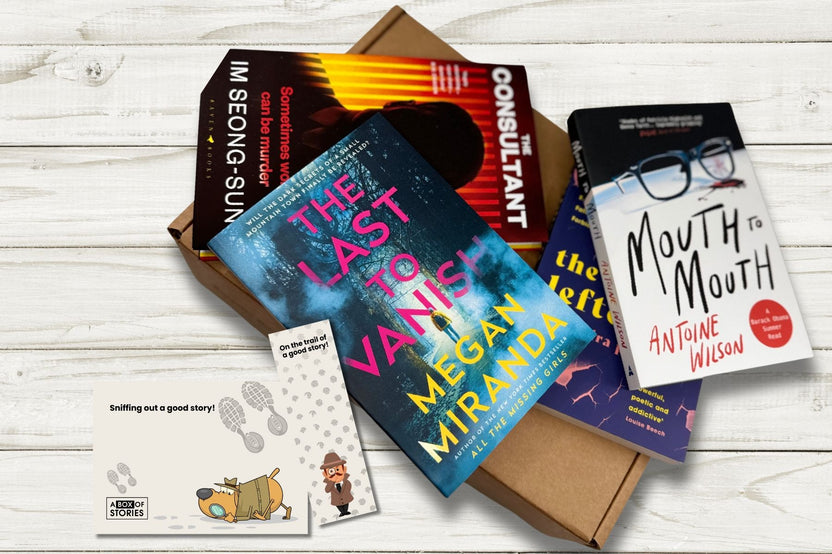 Brown box filled with fiction books, showcasing a variety of gripping titles and intriguing covers, perfect for mystery lovers.