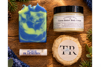 handmade soap bar with bold blue and green marbling displayed with natural skincare ingredients      