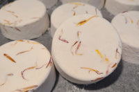 Our bath bombs come with some botanicals, or additives.  Just enough to make them look amazing, and practical at the same time.