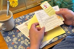 Knit Snail Mail club member with her letter. Each month's mailing includes a letter, cartoon, cookie recipe and fun suprises.