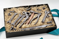 Gift box with chocolate tool set including wrenches, pliers, screws, nuts, and a file, crafted as realistic edible treats