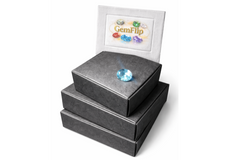 Stack of closed GemFlip black boxes on a white background with a faceted gemstone placed on top, highlighting premium packaging for gemstone