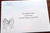 White envelope with printed sample U.S. mailing address and a black outline patriotic bow with stars in the lower-left corner.