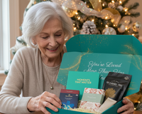 Grandmother opening her Senior Joy Welcome Box, smiling as she discovers comforting, meaningful gifts inside.