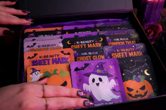 premium Halloween sheet mask shown in a display form in an Halloween themed gift box with the name "The Beauty Gods" brand
