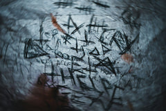 Blury Image with high quality center of it with crazy scratches and writing on a piece of paper and blood.
