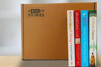 Brown box filled with a diverse collection of books in multiple genres, including crime thrillers, romance, and fantasy