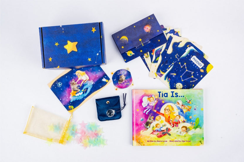 A colorful display of Tía’s Box of Treasures with the 'Tía Is...' book, sensory items, keepsakes, and monthly treasures