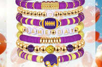 Game Day 8-piece stackable friendship bracelet set in purple and gold beads shown inside a clear square display frame with football, helmet,