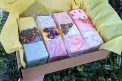 Gift-ready box of colorful marshmallows nestled in yellow tissue paper. Made by The Toasty Smore and are gluten-free