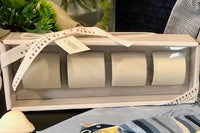 4 gift boxed ceramic napkin rights in white.
