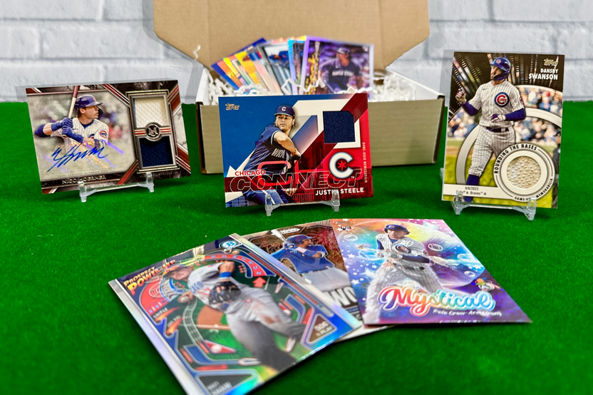 Chicago Cubs baseball cards, including autographs and game-used cards, arranged in display stands on a green carpet.