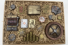 Box with casino-themed chocolates including a roulette wheel, poker chips, wallet, and detailed playing card shaped treats