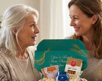Elderly woman smiling while opening a thoughtful gift box filled with meaningful items
Senior enjoying curated comfort products