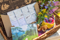 A hand pours tea from a kettle into a cup beside a Tea Runners subscription box and loose leaf tea packages