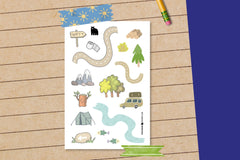 A lined paper and pencil in the background with a make your own map sticker sheet held on my summer themed washi tape.  