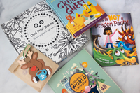 Owl Post Books kids subscription box with holiday gift books Around the World, This Is Not a Dragon Party, and fun reindeer craft.