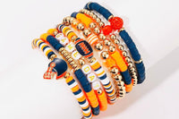 Game Day 8-piece stackable friendship bracelet set in navy blue and orange beads with gold accents, football and helmet charms, and GAME DAY