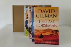 Brown subscription box filled with four historical fiction books, featuring rich narratives and captivating tales set in different eras.