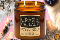 Crazy Cat Lady 16oz double-wick soy candle by The Burlap Bag, grapefruit scented amber jar surrounded by cat faces on pink