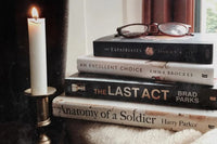 Brown box filled with fiction books, showcasing a variety of gripping titles and intriguing covers, perfect for mystery lovers.