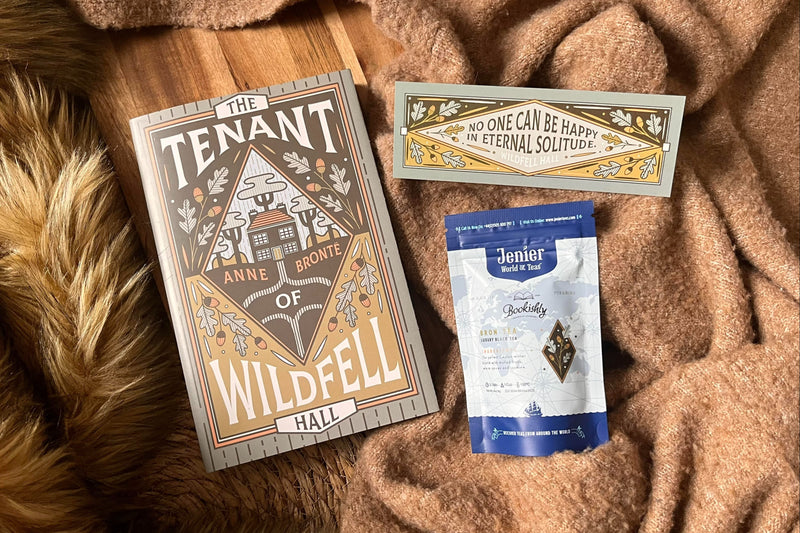 A classic novel and loose leaf tea on a soft brown blanket