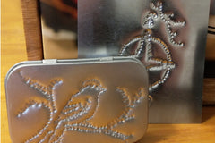 Projects made with our Punched Tin Crate - a wallet tin with a Carolina wren sitting on a branch and a compass rose on a square.
