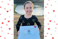 Happy child with February Activity Box. February Valentine's box with 20 OT activities, crafts, sensory materials, and fine motor tools for 