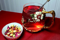 A shot of my Strawberry Moonrise tea in loose leaf form with a steeped version in the glass next to it.